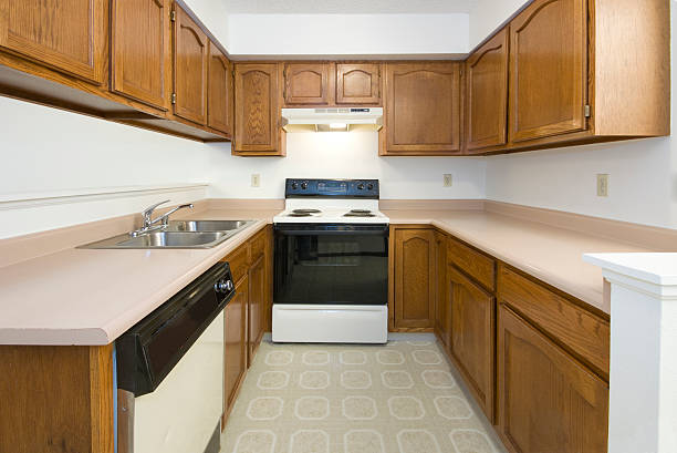 Outdated kitchen with traditional wood cabinets and older style finishes